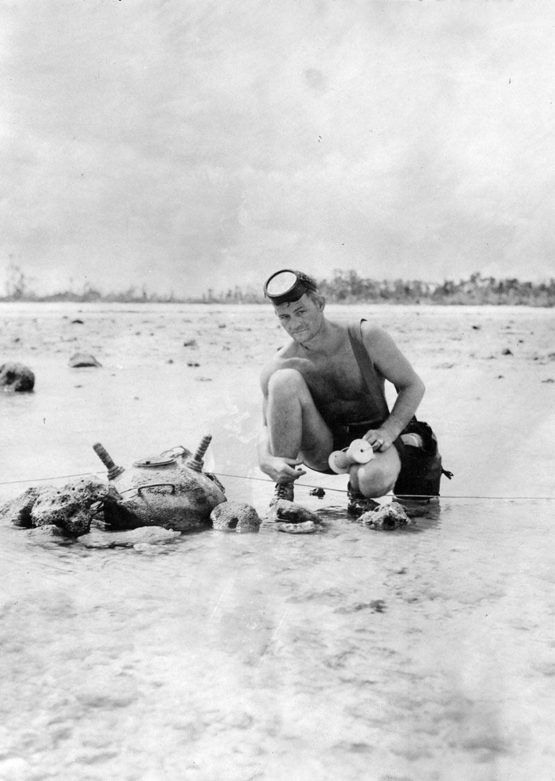 Figure 3: Andy Anderson, GM1/c, of UDT7, with a J-13 mine at Peleliu. This type of ‘horned’ mine was particularly dangerous because it was so unstable.