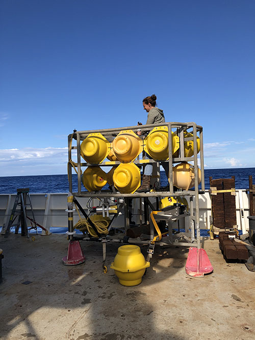 Furu Mienis works to secure benthos spheres—glass spheres enclosed in yellow plastic used for floatation—on the lander before its test deployment.