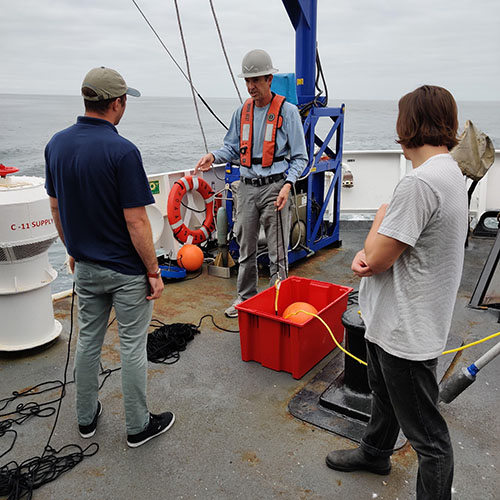 Crew of the NOAA Ship Fairweather preparing to deploy a drifting acoustic buoy off Northern California.
