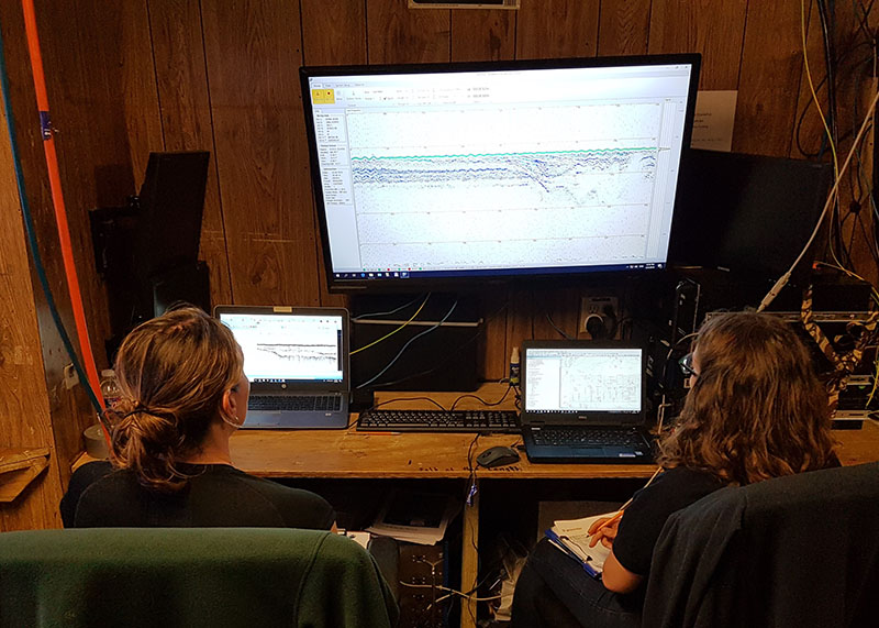 Amanda Evans (left) and Megan Metcalfe (right) monitor acquisition of the parametric sonar data onboard the R/V Nikola during fieldwork in 2019.