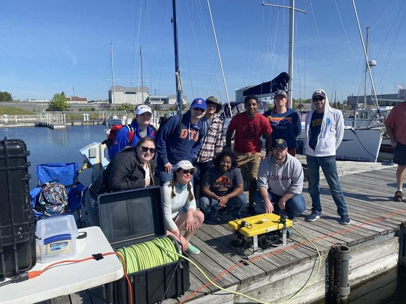 Underwater Archaeology Field School students and Dr. Ashley Lemke with the research remotely operated vehicle used during the Discovering the Submerged Prehistory of the Alpena-Amberley Ridge in Central Lake Huron expedition.