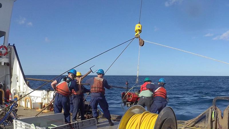 The U.S. Coast Guard deck operations team launching remotely operated vehicle