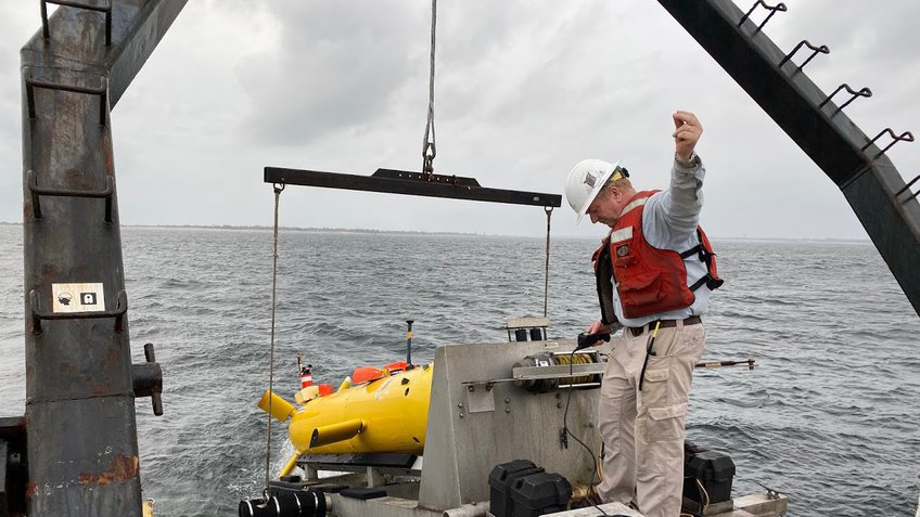 A test launch of the Eagle Ray autonomous underwater vehicle in the brackish waters of Pensacola Bay with Arne Diercks in the photo. Image courtesy of Vernon Asper.