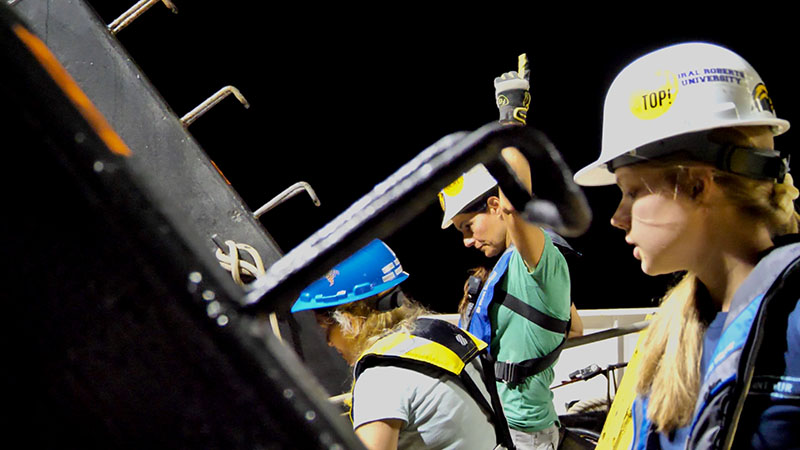 Left to right, Melanie Damour, Bureau of Ocean Energy Management Marine Archaeologist, co-chief scientist, Leila Hamdan with the University of Southern Mississippi, and University of Southern Mississippi doctoral student, Rachel Mugge standing on the back deck of Research Vessel Point Sur, recovering the Klein System 4000 side-scan sonar during the August 2021 expedition. The Search for SS Norlindo expedition team has striven to be diverse, welcoming, and inclusive and has placed emphasis on empowering the next generation of scientists with oceanographic leadership and communication skills.