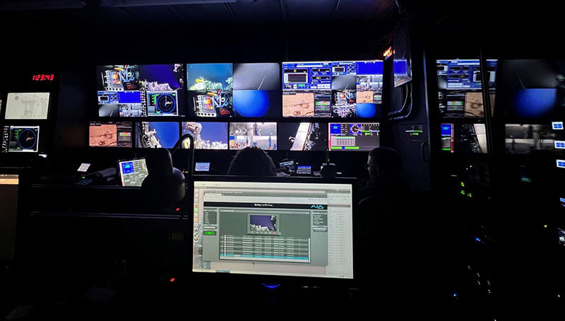 AThe remotely operated vehicle control room with its many monitors busy displaying live video from the seafloor during the Escanaba Trough: Exploring the Seafloor and Oceanic Footprints expedition.