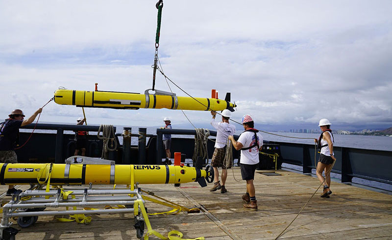 During the Deepwater Surveys of World War II U.S. Cultural Assets in the Saipan Channel expedition the team will conduct surveys using a REMUS 600 autonomous underwater vehicle, like the one shown here being deployed in 2021. The REMUS 600 can carry a suite of sensors, including sidescan sonar and a low-light camera system, and will reach depths as great as 600 meters (1,968 feet).
