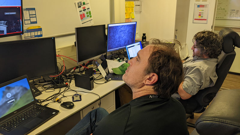 Mike Rasser of the Bureau of Ocean Energy Management (left) and Jason Chaytor of the U.S. Geological Survey (right)  review data collected by the HUGIN autonomous underwater vehicle from the study area of Deep Helder during 2022’s Investigation of a Historic Seabed Mining Equipment Test Site on the Blake Plateau.