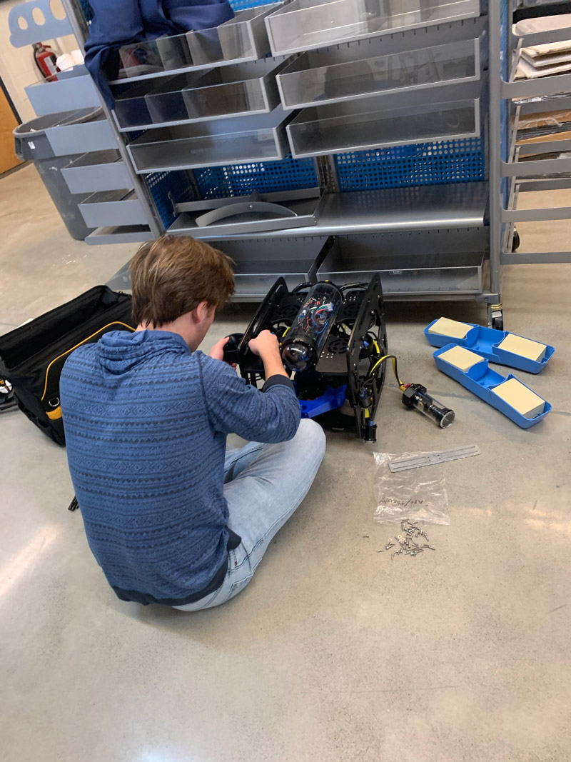 Mason Pesson, an undergraduate/master’s student at Louisiana State University (LSU), assembles LSU’s autonomous underwater vehicle Dory in preparation for field trials for the Machine Learning for Automated Detection of Shipwreck Sites from Large Area Robotic Surveys expedition.