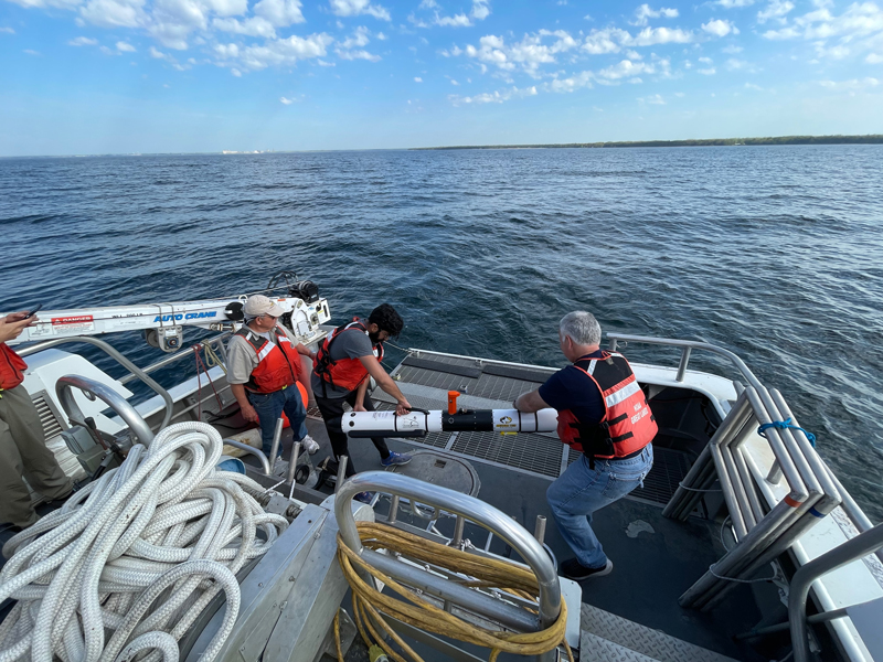 The Machine Learning for Automated Detection of Shipwreck Sites from Large Area Robotic Surveys expedition team prepares to launch autonomous underwater vehicle Iver 3 from the back deck of NOAA Research Vessel Storm.