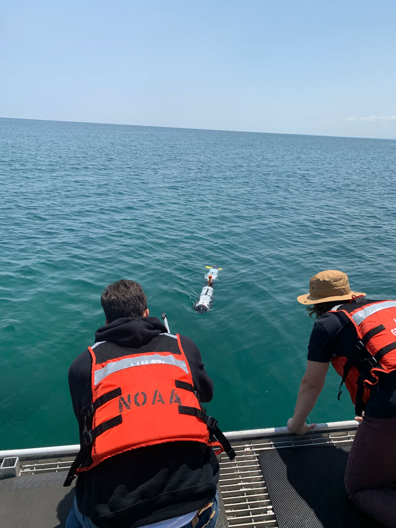 University of Michigan graduate students, Onur Bagoren and Anja Sheppard, prepare to recover the Michigan Technological University IVER autonomous underwater vehicle after a mission is completed.