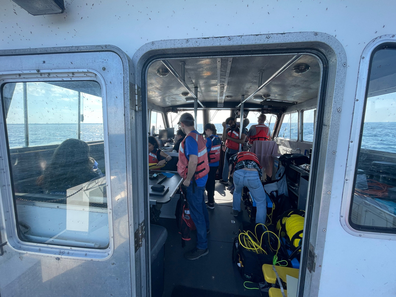 The Machine Learning for Automated Detection of Shipwreck Sites from Large Area Robotic Surveys expedition team hard at work on NOAA Research Vessel Storm.
