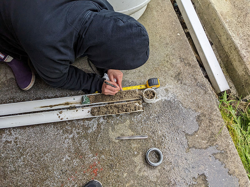 Sealaska Heritage Institute intern Taylor Heaton recording a sediment core collected during the Our Submerged Past expedition.