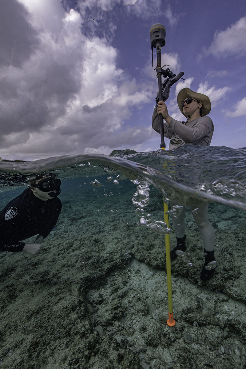 Liza Hasan and Anne Wright collecting GPS data inside reef blast craters at the Asan unit of War in the Pacific National Historical Park. 