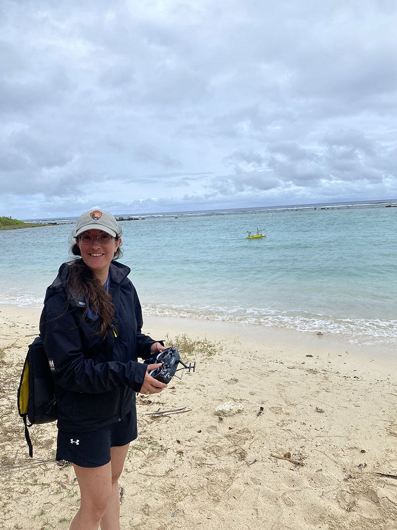 Monique LaFrance Bartley driving an uncrewed surface vessel via remote control during system preparation at the Asan unit of War in the Pacific National Historical Park.