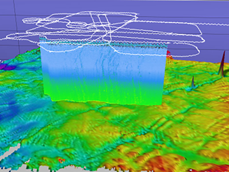 A colorful 3D topographical map with a blue to green prism and white outlines above.