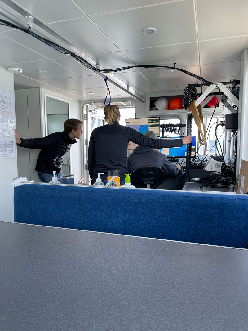 Researchers reviewing remote sensing data aboard Research Vessel Storm Petrel as the data is being collected.