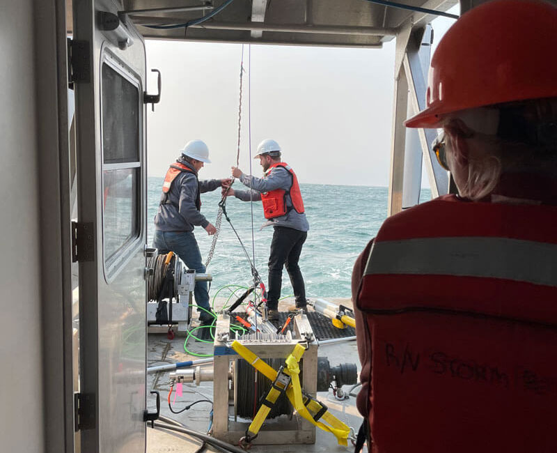 Deploying remote sensing equipment on Research Vessel Storm Petrel.