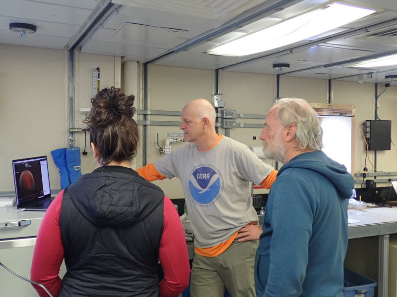 Jennifer Questel, Allen Collins, and Russ Hopcroft (left to right) talk to visitors at the Smithsonian National Museum of Natural History in Washington, DC, from Research Vessel Sikuliaq, about the project and life at sea.