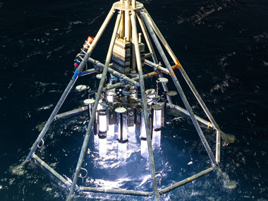 The multicorer being lowered into the ocean from Research Vessel Falkor (too) to collect data for the Exploring Deep-Sea Methane Seeps Along the Chile Margin project. The device can retrieve multiple sediment and water samples from the seafloor during a single deployment.
