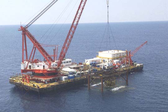 Engine being lifted to barge