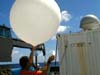 Releasing radiosonde attached to weather balloon