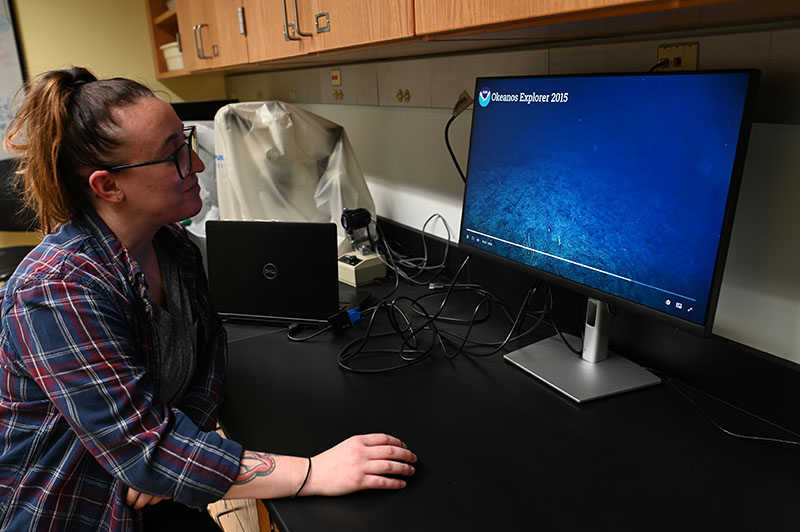 Undergraduate researcher Nikki Fuller analyzes NOAA video footage recorded with remotely operated vehicle Deep Discoverer to determine abundance and diversity of deep-sea fishes.