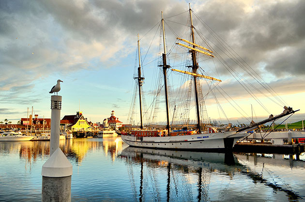 Taken on April 1st of 2013 in Rainbow Harbor, Shoreline Village, Long Beach, California. The great Tole Mour ship rests on this calm day. In the background is shoreline village and a seagull who was very cooperative and patient in allowing me find the perfect perspective let me take this shot with him in it. The Seagull standing guard makes this shot to me.