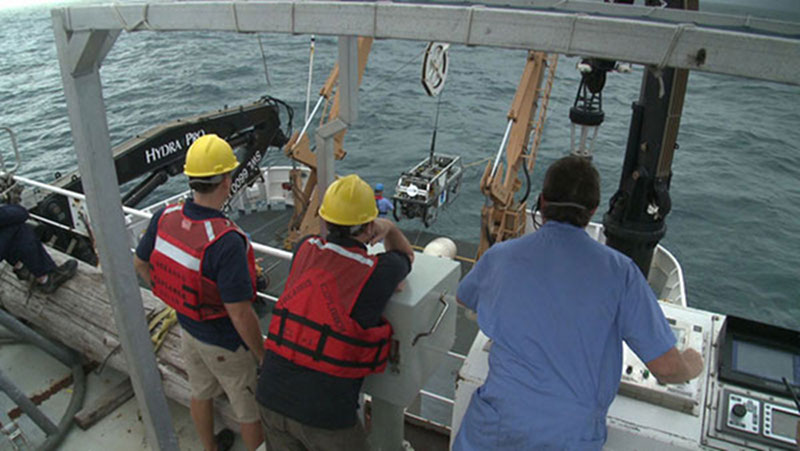 Ship and Mission personnel at the aft control station monitor the final ROV and camera sled recovery of the Galapagos Expedition.
