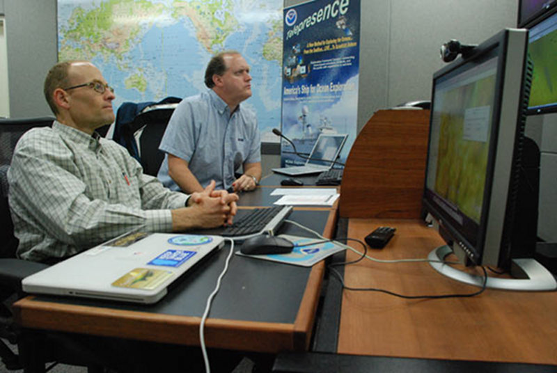 Scientists Scott White and Jim Holden observe the video feed from Little Hercules and record their observations.