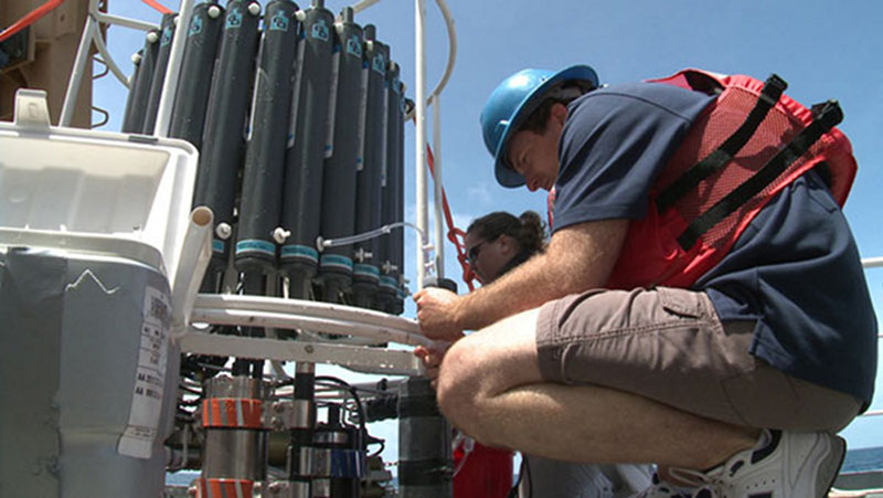 The ‘CTD rosette’ includes conductivity, temperature, and depth sensors and a ring of gray Niskin water bottles.