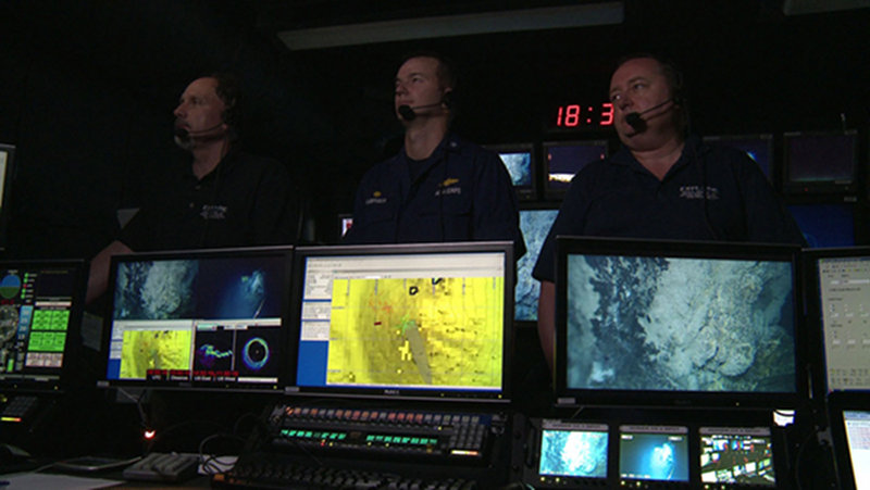 Our hosts on the Okeanos Explorer: (from left) ROV Team Lead Dave Lovalvo, Commanding Officer Robert Kamphaus, and Science Team Lead Chris German talking about our operations at the Mid-Cayman Rise.