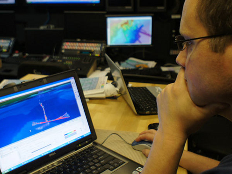NOAA Corp's commissioned officer LTJG Glen Rice works on processing multibeam sonar seep data on board NOAA Ship Okeanos Explorer.