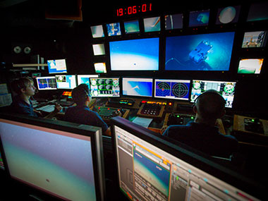 The control room of the Okeanos is as well coordinated as any live television studio.