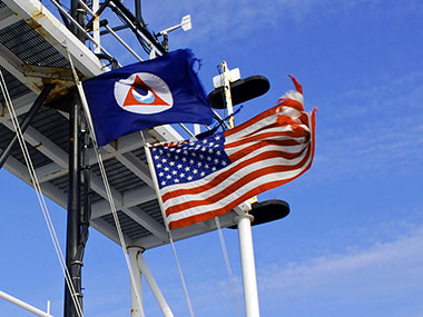 The NOAA and American flags fly above NOAA Ship Okeanos Explorer.