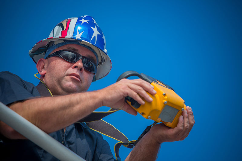 Tyler Sheff, Chief Boatswain, operates ROV Deep Discoverer’s crane with a wireless control.