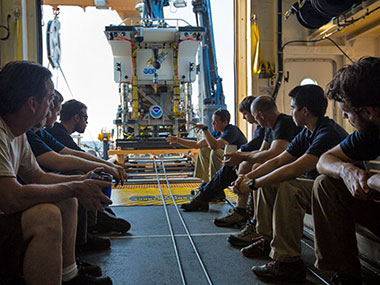 Dr. Brian Bingam conducts a pre-dive briefing with the ROV team.