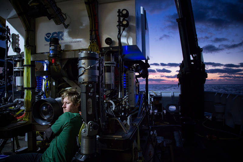 An artist in his medium. Todd Gregory works to fine tune the HD camera system at sunset onboard NOAA Ship Okeanos Explorer