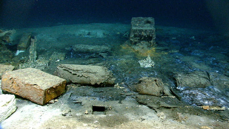 Monterrey Wreck B is different than Monterrey Wrecks A and C. It contains a great deal of organic material and the hull is not copper sheathed like the other two. Monterrey B likely represents a merchant vessel dating to the early 19th century and carried a cargo of animal hides and large white blocks. The composition of these blocks is unknown, but they may be tallow rendered from animal fat. This photo shows several roles of hides and a white block on the far left. Several unopened wooden crates remain intact and the ship's stove is in the background.