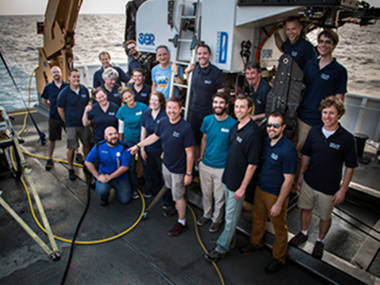 The on-ship exploration team poses with D2 at the end of the expedition.