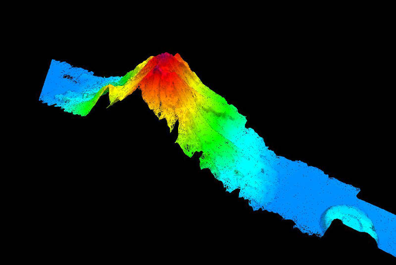 An unnamed seamount was mapped during our transit mapping operations today. The 2,865-meter high seamount's peak is 562 meters below the surface of the water, with surrounding water depths of 4,709 meters.