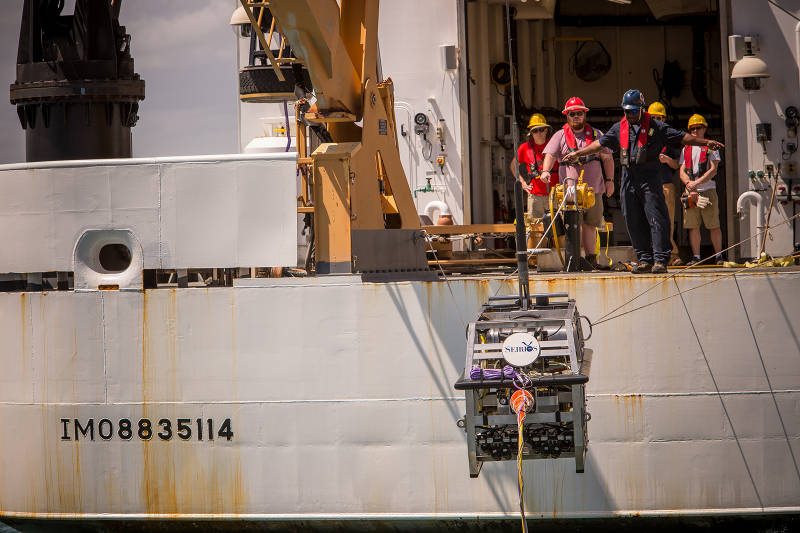 Able-bodied Seaman Abe McDowell directs deck operations during remotely operated vehicle deployment operations.