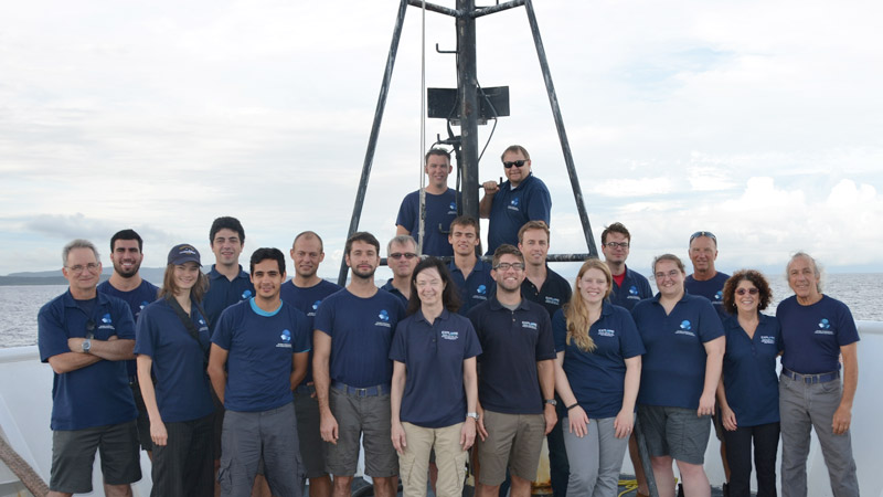 The shipboard mission team poses on the bow of the ship as Leg 3 comes to a close.