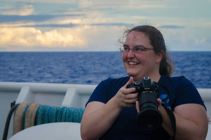 Annie White is taking still photos of the crew and staff on the Okeanos Explorer while they go about their daily tasks. Image courtesy of NOAA Ocean Exploration, Discovering the Deep: Exploring Remote Pacific MPAs.