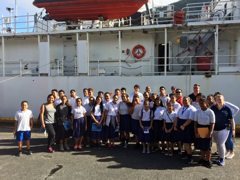 Students from American Samoa tour NOAA Ship Okeanos Explorer. Seen on the far right of the second row is Expedition Coordinator Kasey Cantwell and on the far right of the last row is the expedition mapping lead, Mike White.