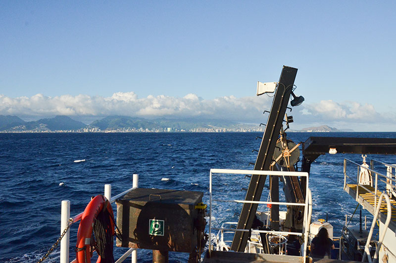 Image of the starboard aft deck of NOAA Ship Okeanos Explorer leaving Oahu and beginning a more than two-day transit to the Johnston Atoll Unit of the Pacific Remote Islands Marine National Monument.