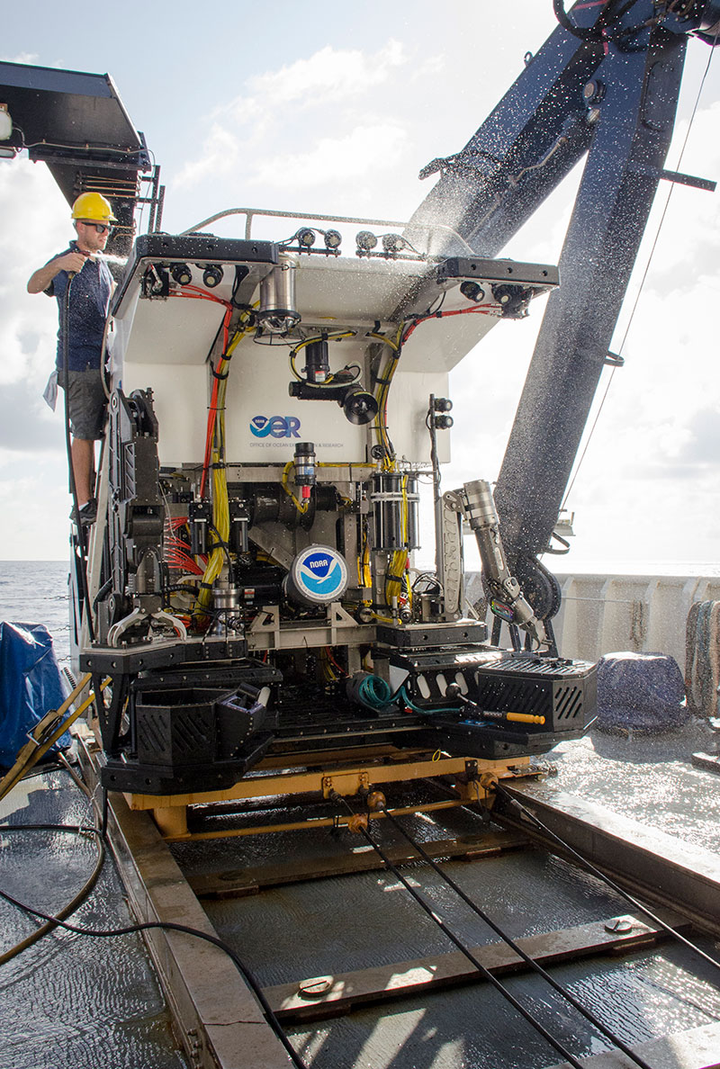 Dive Supervisor, Dan Rogers, rinses remotely operated vehicle Deep Discoverer with freshwater following the last dive of the Laulima O Ka Moana expedition.