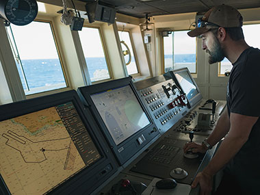 Kongsberg DP Technician, Michael Neal, verifies input signals to the ship's dynamic positioning system after upgrades were made during the ship's dry dock period.