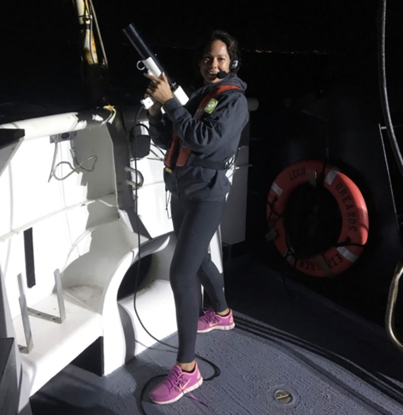 NOAA EPP Intern, Nikola Rodriguez, gets ready to deploy the Expendable Bathythermograph (XBT) off the aft deck of NOAA Ship Okeanos Explorer. XBTs are launched every ~2-6 hours to acquire temperature data of the water column down to 760 meters (2,493 feet). These data are used to estimate water column refraction required for multibeam sonar data.