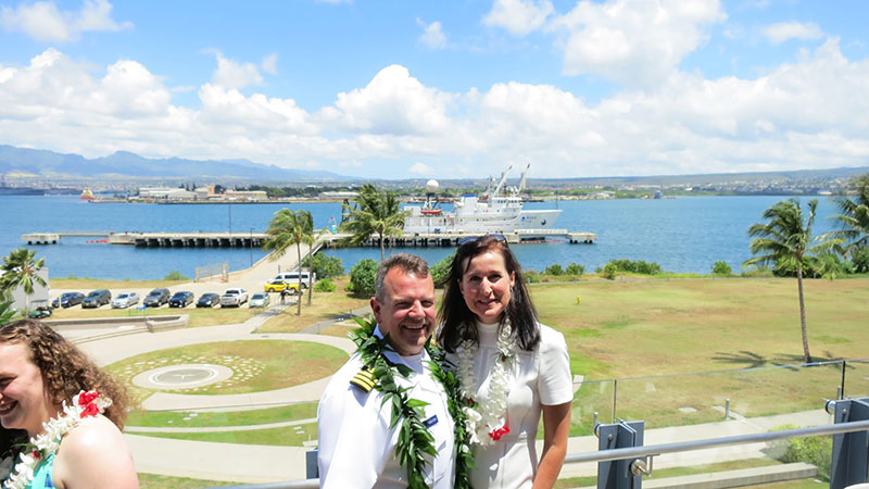 Eric Johnson with his wife, Angela, and NOAA Ship Okeanos Explorer in the background during the Change of Command in July 2017.