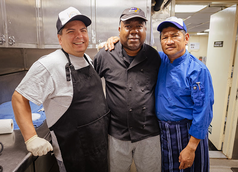 Chief Steward, Mike Sapien; Second Cook, Will Johnson; and Chief Cook, Ray Capati in the galley aboard NOAA Ship Okeanos Explorer.